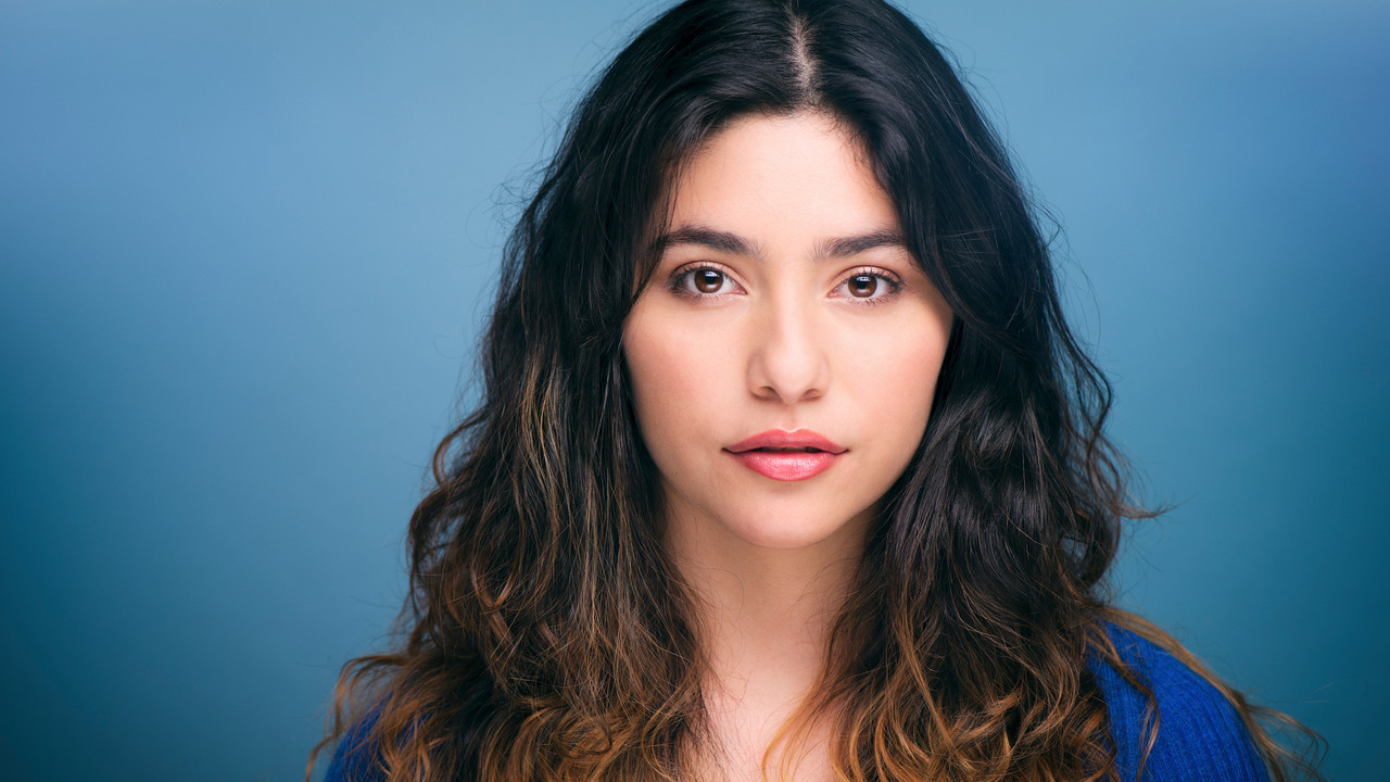 Headshot of Gabriela Torres against a blue background