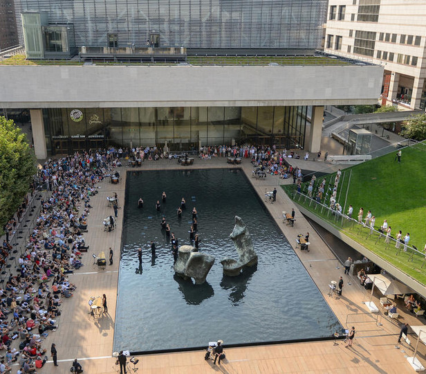 Lincoln Center plaza full of event attendees on a sunny day