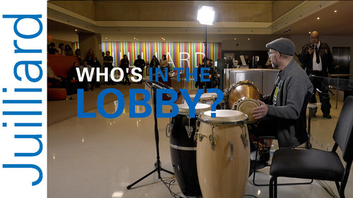Man playing drums in Juilliard lobby
